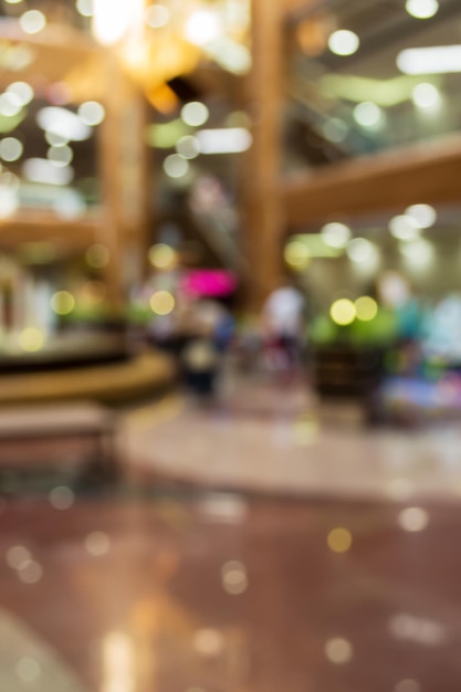 Blurred background: interior of shopping mall gallery.