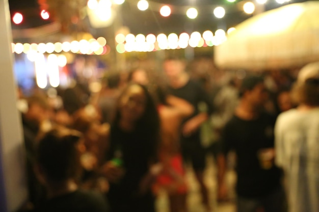 Blurred background of many people had fun at a beach party