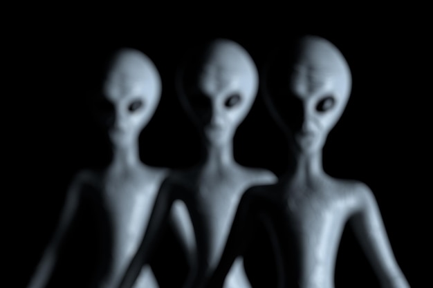 Photo blurred background row of scary gray humanoid aliens 3d rendering
