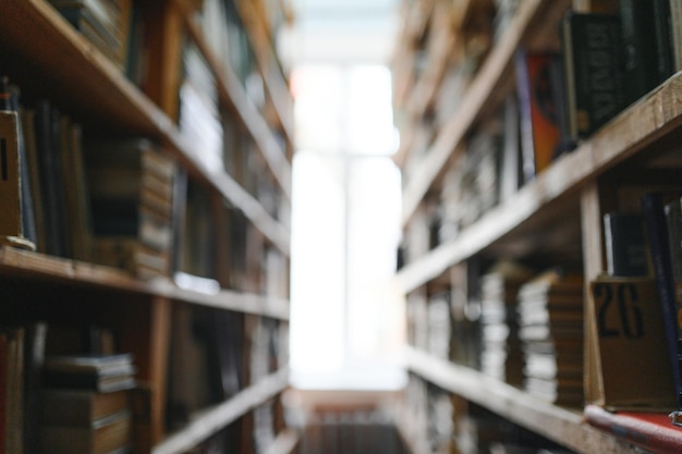 Blurred background of shelf with many multicolored books