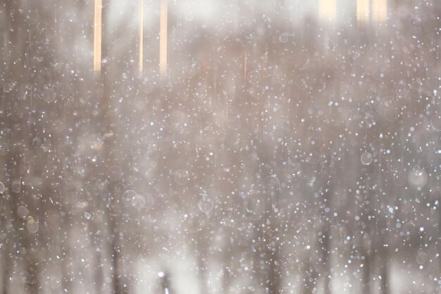 Blurred background snowfall nature, abstract falling snowflakes\
design