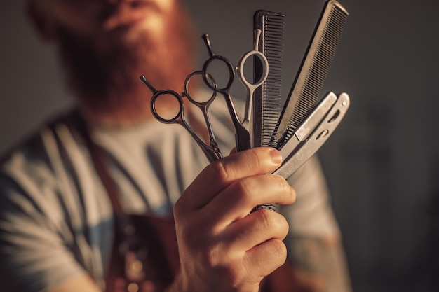 Blurred barber demonstrating tools