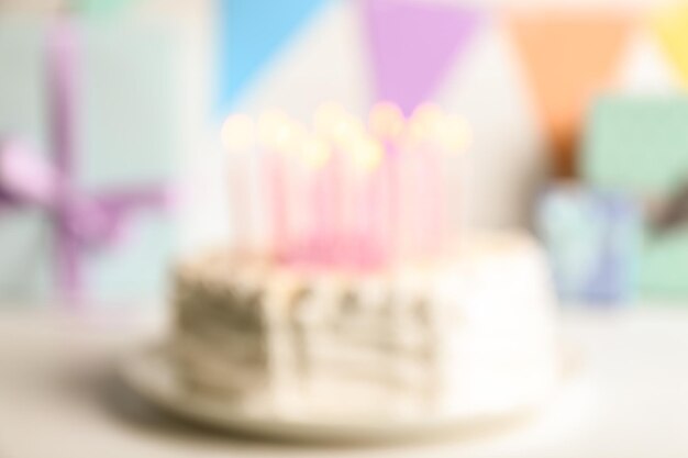 Blurred Birthday cake with candles on light background