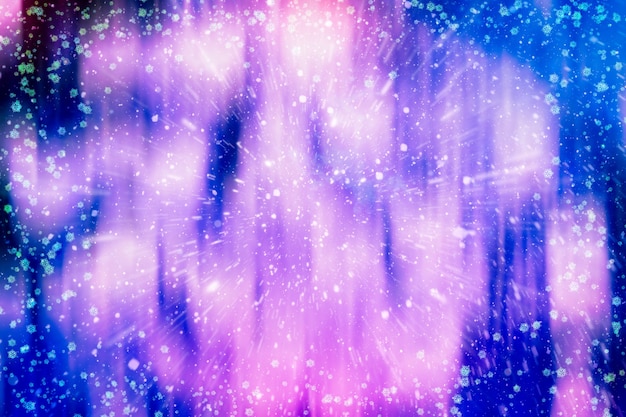 Blurred bokeh christmas background with snowflakes . Light abstract Christmas background with snowflakes and stars
