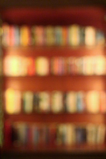 Blurred of books in the bookshelf at the public library Education and books day background concept