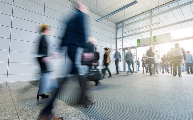 blurred Business people walking in the trade fair corridor