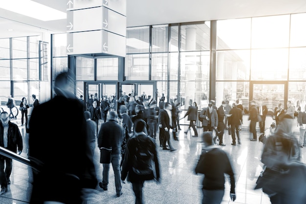 Blurred business visitors rushing on a tradeshow entrance.\
ideal for websites and magazines layouts