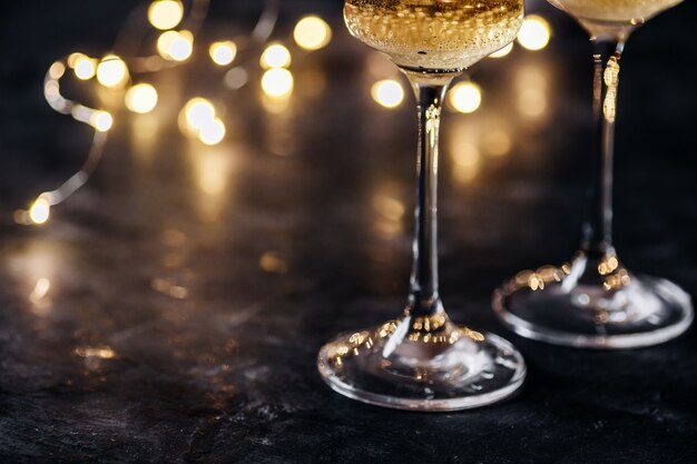 Blurred christmas background with glasses of champagne with garland