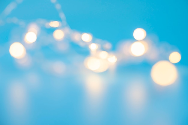 Blurred Christmas garlands on blue background