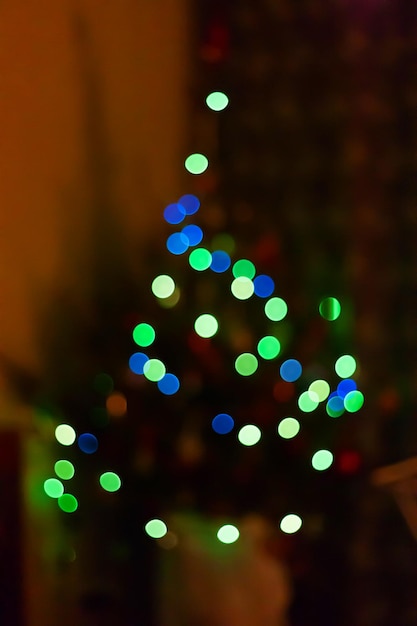 Blurred christmas tree with lights Blue and green lights