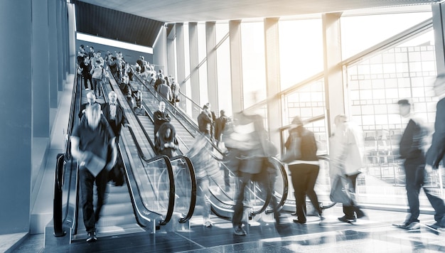 Blurred commuters on escaltors in a  business center. ideal for websites and magazines layouts