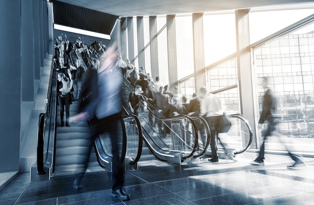 Blurred commuters on escaltors at a tradeshow. ideal for websites and magazines layouts