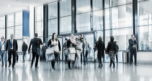 Blurred commuters walking on a business center floor. ideal for\
websites and magazines layouts