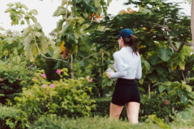 Blurred concept of woman exercise jogging in the park