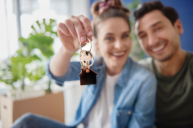 Photo blurred couple holding keys for a new house