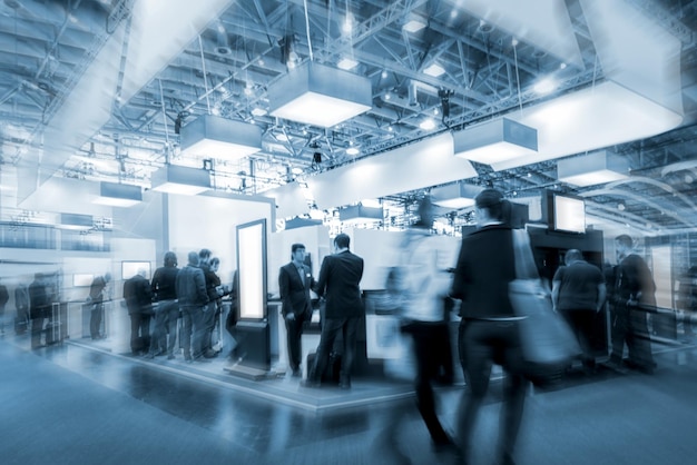 Photo blurred crowd on a exhibition with trade fair booths. copyspace for your individual text.