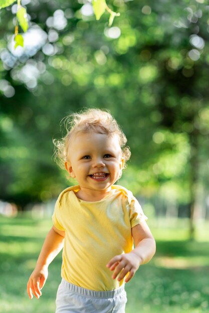 Blurred curly girl in motion running on a blurred green background