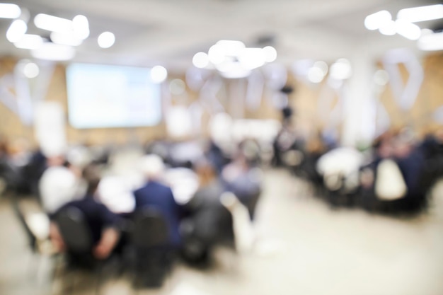 Blurred defocused audience. Blur of business conference and presentation in the conference room.