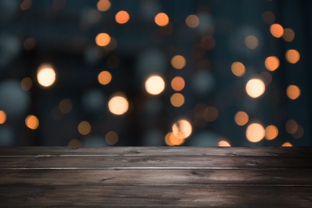 Blurred gold garland and wooden tabletop as foreground. 