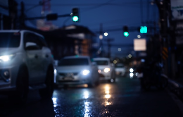 Blurred image of cars on wet road after hard rain fall in the city.