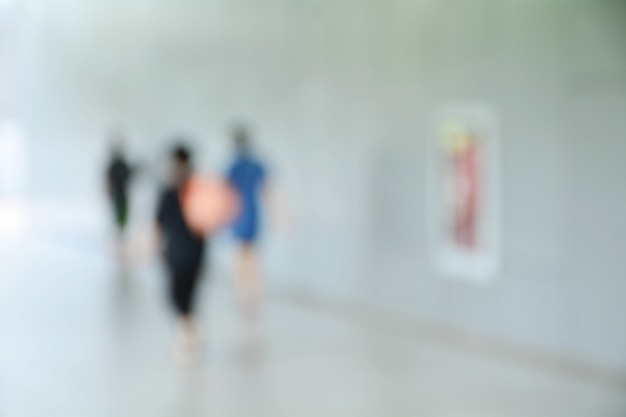 Blurred image of people at sidewalk in the city.