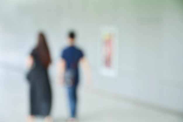 Blurred image of people at sidewalk in the city.