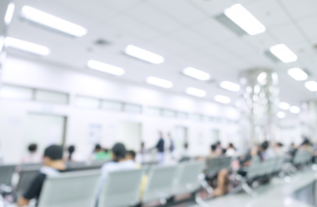 Blurred interior of hospital or clinical with people - abstract medical background.