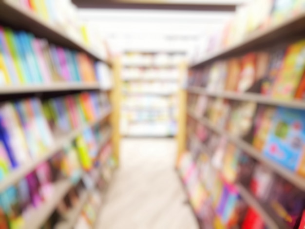 Blurred of interior of the library with books in bookshelves. Education and book's day concept.