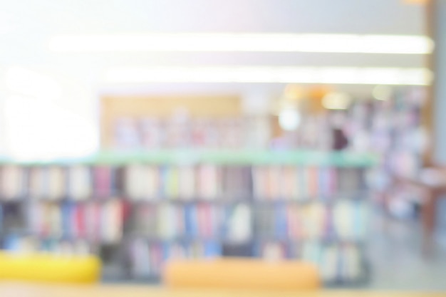 Photo blurred of the interior of the public library with books in bookshelves. education and book's day.