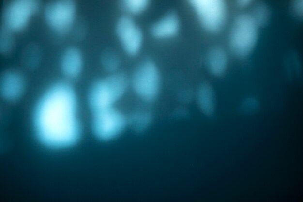 Photo blurred light texture background with shadow on the blue wall