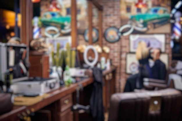 Blurred loft stylish barbershop interior with wooden countertops and leather chairs