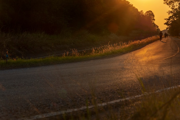 Blurred man is jogging on street among the sun light