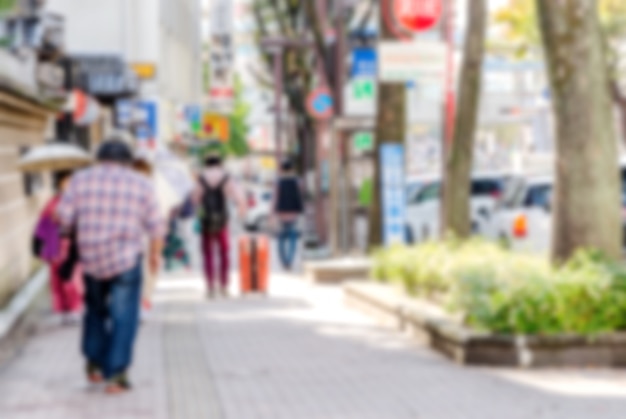 Blurred man walking on a city street.