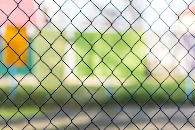 Blurred metal mesh on a blurred green background closeup