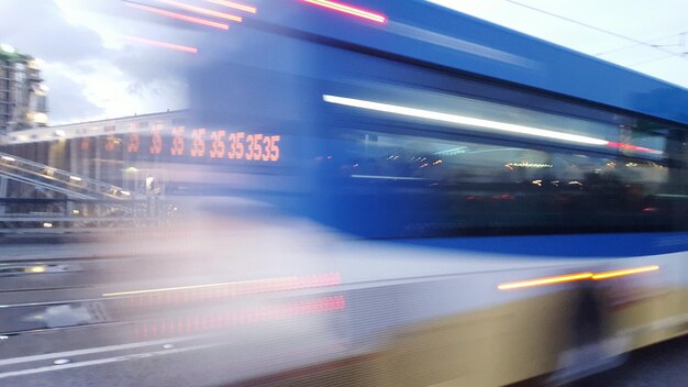 Blurred motion of bus on road in city