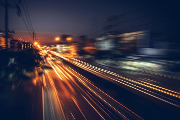 Photo blurred motion of light trails on street at night