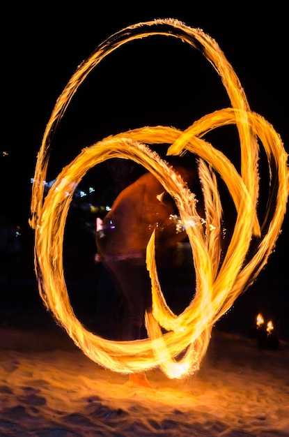 Photo blurred motion of woman dancing against sky at night