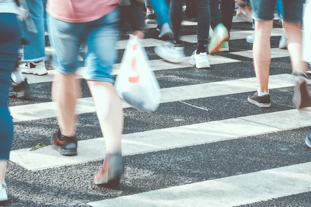 Blurred people crossing the street on a zebra crossing