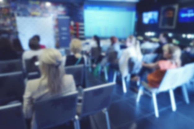 Photo blurred people during presentation in conference hall