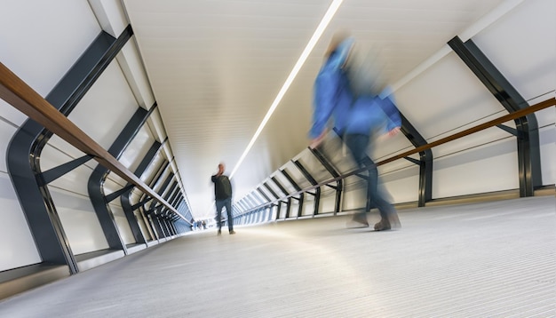 Blurred people in a futuristic tunnel