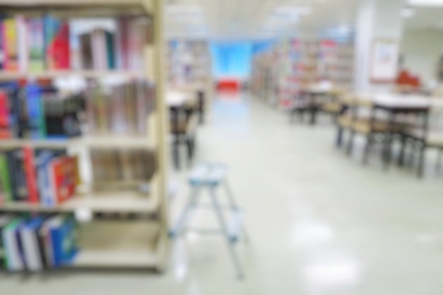 Blurred of the public library with books in bookshelves. Education and book's day.