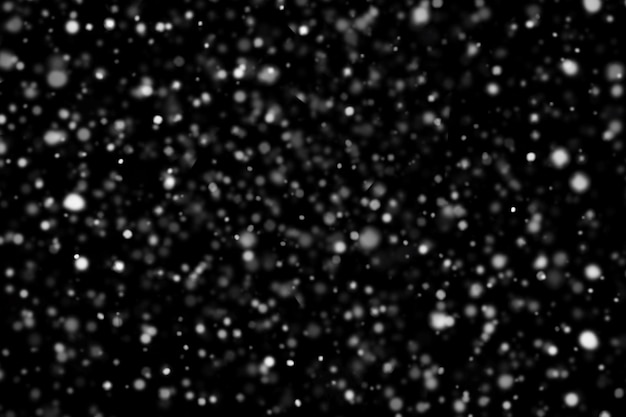 Blurred snow texture on a black background christmas and winter concept winter snow template