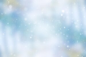 Blurred snow / winter abstract background, snowflakes on abstract blurred glowing leaf background