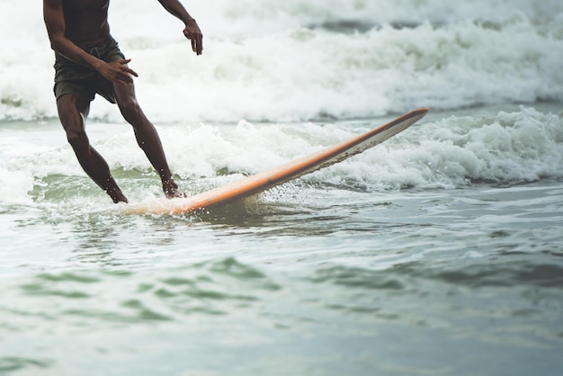 Blurred soft images of people are playing surfboard in the sea