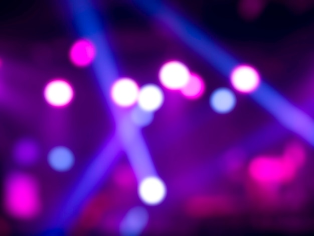 Blurred stage light concert background with colorful beam and laser rays on stage