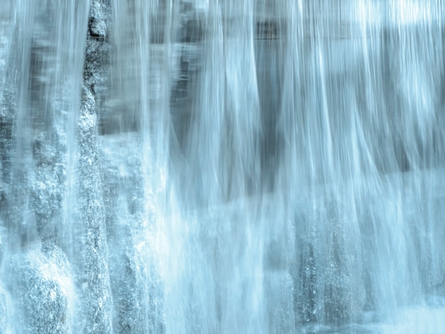 Blurred stream of water. Beautiful view of flowing water.