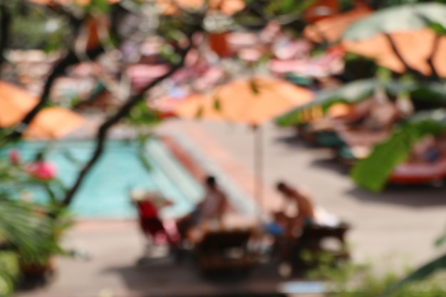 blurred swimming pool with umbrellas