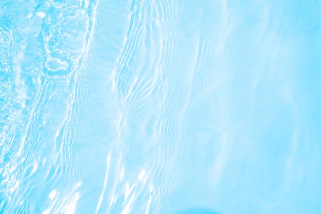 Photo blurred transparent blue colored clear calm water surface texture with splashes and bubbles trendy abstract nature background water waves in sunlight water background