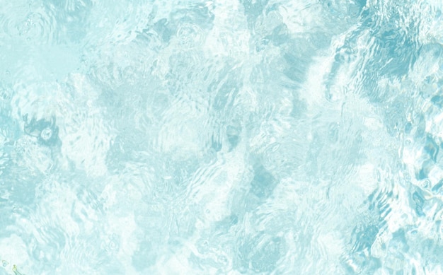 Blurred transparent blue colored clear calm water surface texture with splashes and bubbles Trendy abstract nature background Water waves in sunlight water background