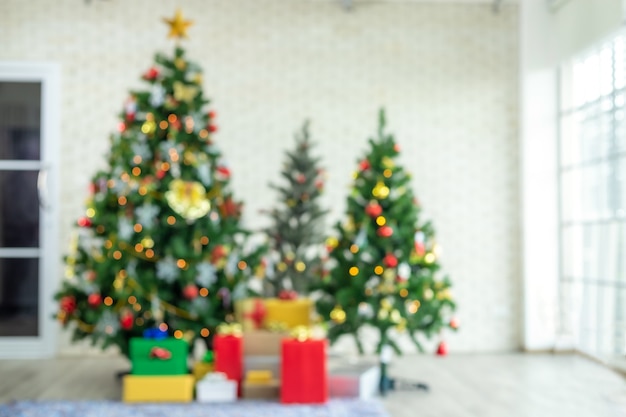 Blurred view of Christmas tree with red gifts. Decoration During Christmas and New Year.